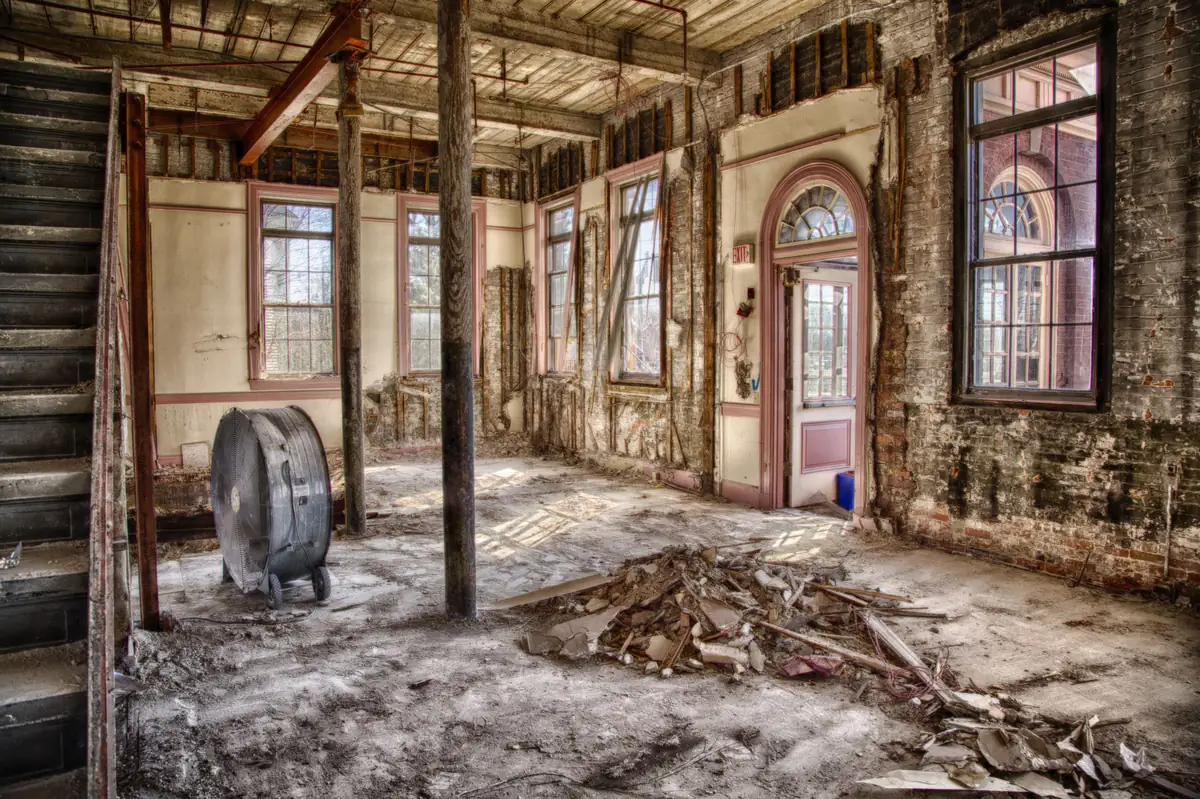 Building interior stripped back to brick, framing and subfloor during selective demolition